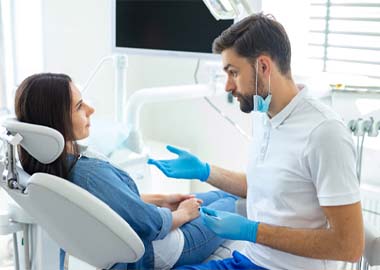 Dentist explaining All-on-4 in Granby to a patient