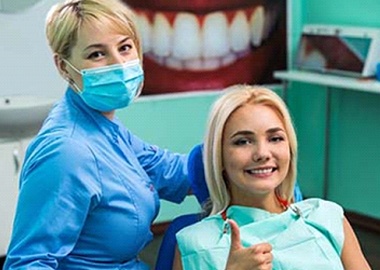Woman smiling with dentist in Granby