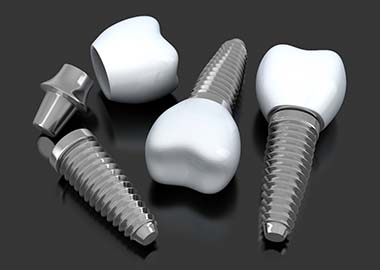 three dental implants lying on a flat surface