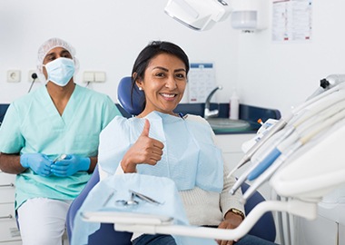 A smiling woman who received effective dental care