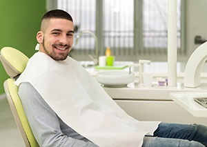 Male dental patient smiling and waiting for treatment