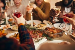 family sitting around a table enjoying holiday foods