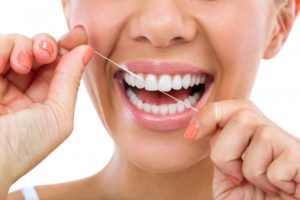 woman flossing for healthy gums