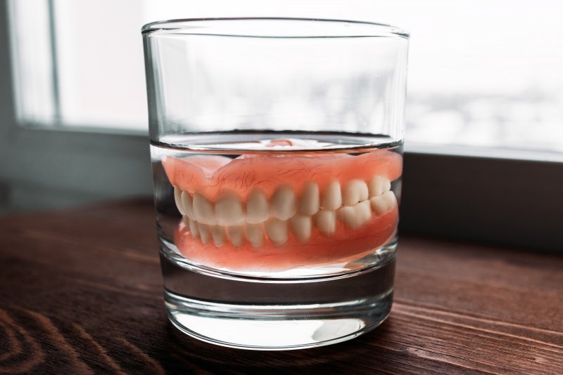 Pair of dentures in a glass of water