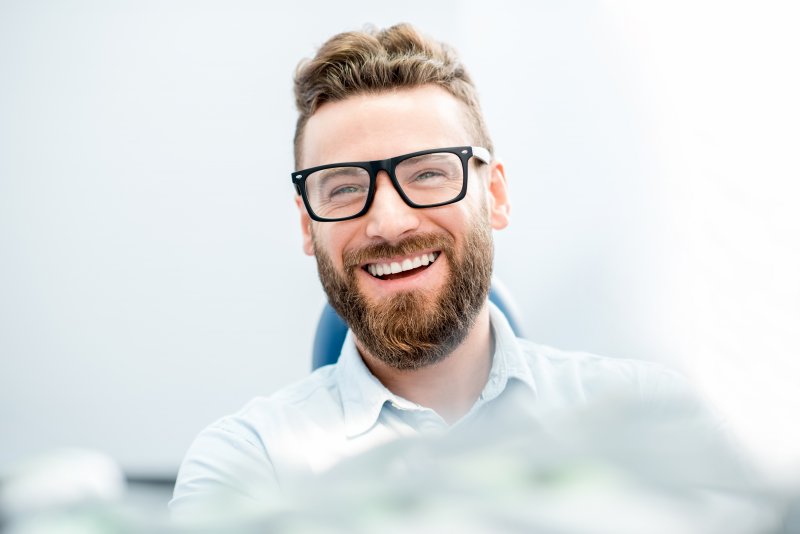 person smiling at their cosmetic dentist’s office