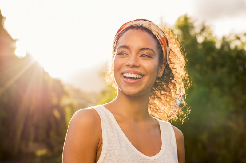 A young woman smiling at sunset