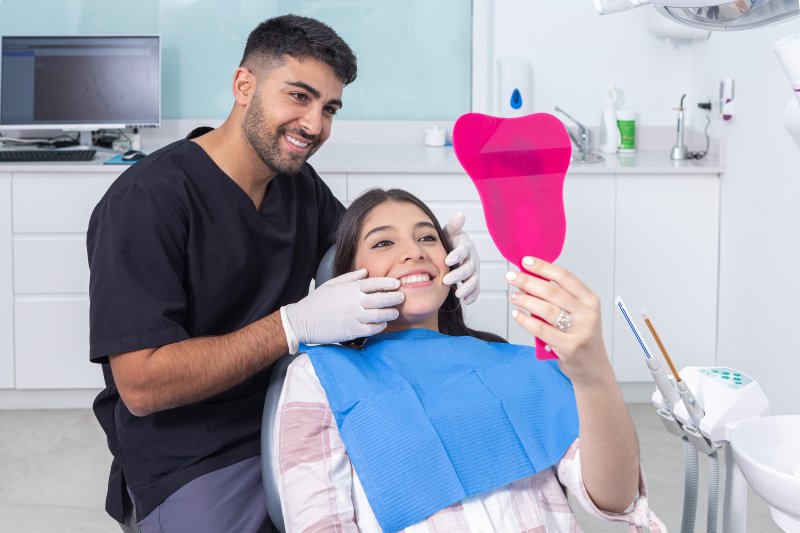 A teenage girl admiring her cosmetic dental results